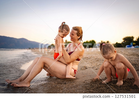 Summer moments by the Greek seaside with family 127531501