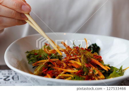 Exploring vibrant flavors in a vibrant Chinese dish during a joyful mealtime moment Exploring vibrant flavors in a vibrant Chinese dish during a joyful mealtime moment 127533466