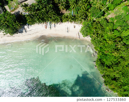 Tropical landscape with fishing boats over sandy beach. Carabao Island, Romblon. Philippines. 127533860