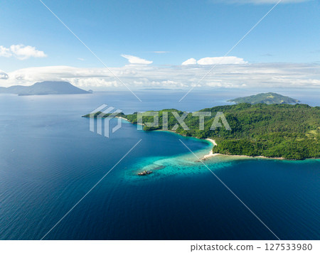 Tropical sandy beach in Islands surrounded by blue sea. Romblon, Philippines. 127533980