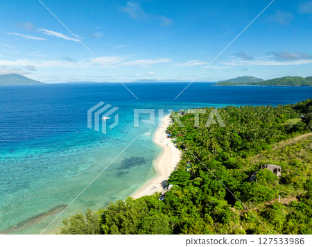 White sandy beach with clear sea water. Blue sky and clouds. Logbon Island. Romblon, Philippines. 127533986