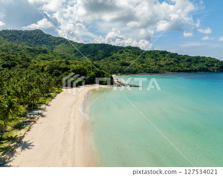 Diapela Beach with clear turquoise sea water and white sands. Coconut trees and fishing boats. El Nido, Philippines. Diapela Beach with clear turquoise sea water and white sands. Coconut trees and fishing boats. El Nido, Philippines. 127534021