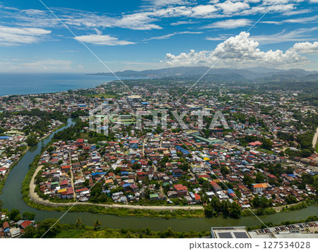 Village in riverside of Iligan City. Blue sky and clouds. Northern Mindanao, Philippines. Village in riverside of Iligan City. Blue sky and clouds. Northern Mindanao, Philippines. 127534028