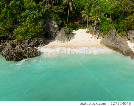 Sea waves rocks and white sand beach in Carabao Island. San Jose, Romblon. Philippines. Sea waves rocks and white sand beach in Carabao Island. San Jose, Romblon. Philippines. 127534046