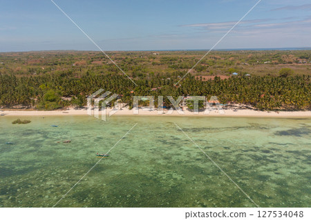 Scenic landscape of shoreline with fishing boats and sandy beaches. Bantayan Island, Cebu, Philippines. Scenic landscape of shoreline with fishing boats and sandy beaches. Bantayan Island, Cebu, Philippines. 127534048