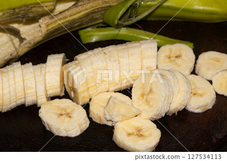 Banana slices on a cutting board 127534113