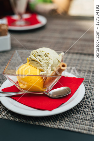 Pistachio and mango gelato in italian cafe 127534192