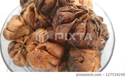 Ready-to-Eat Black Garlic in a Bowl.  127534249