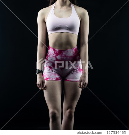 athletic female body on dark background, fitness woman, athletic girl torso 127534465