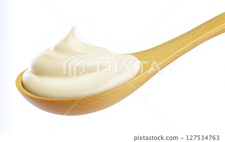 Mayonnaise swirl on wooden spoon isolated on white background with clipping path, copy space 127534763