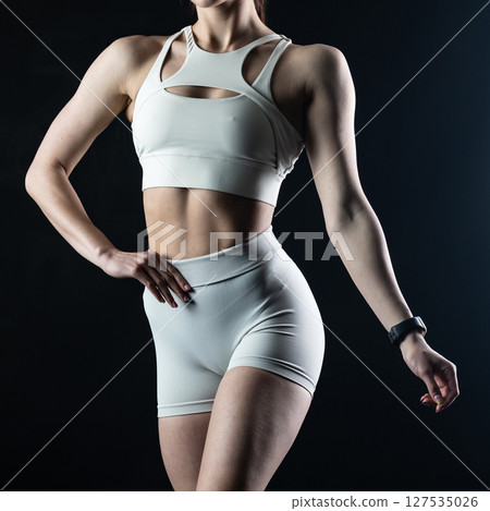 athletic female body on dark background, fitness woman, athletic girl torso 127535026