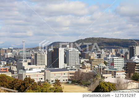 Kumamoto, Japan - January 25, 2023: Landscape of Kumamoto city from Kumamoto castle. Kumamoto is the capital city in Kyushu, Japan. Kumamoto, Japan - January 25, 2023: Landscape of Kumamoto city from Kumamoto castle. Kumamoto is the capital city in Kyushu, Japan. 127535297