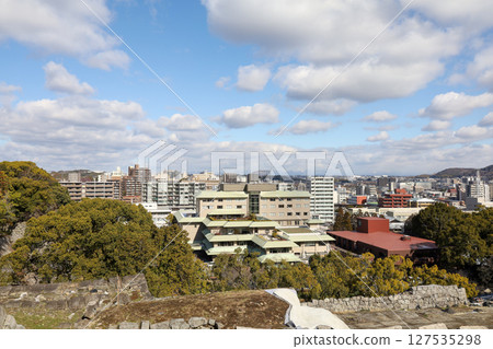 Kumamoto, Japan - January 25, 2023: Landscape of Kumamoto city from Kumamoto castle. Kumamoto is the capital city in Kyushu, Japan. Kumamoto, Japan - January 25, 2023: Landscape of Kumamoto city from Kumamoto castle. Kumamoto is the capital city in Kyushu, Japan. 127535298