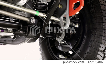 Car suspension part. Close up of a rear car suspension and exhaust system. such as coil springs link arms axle housing and performance exhaust. For auto engineering or car suspension part industry use 127535807