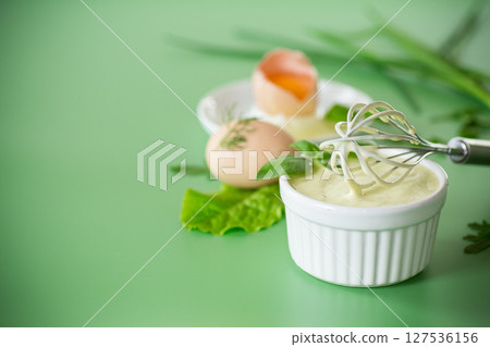 Top view of homemade mayonnaise with green herbs and eggs Top view of homemade mayonnaise with green herbs and eggs 127536156