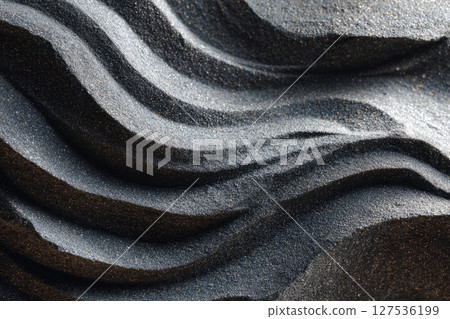 Volcanic black sand texture with natural flowing wave pattern 127536199
