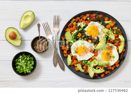 fried sweet potato cubes, eggs, and fresh avocado 127536462