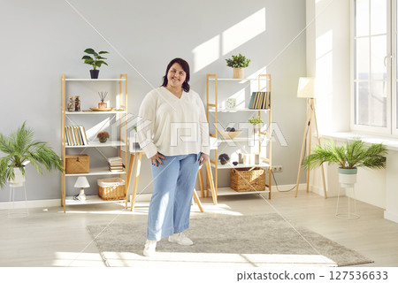 Portrait of a fat plus size brunette woman standing at home and smiling. Portrait of a fat plus size brunette woman standing at home and smiling. 127536633