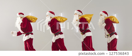People in Santa Claus suits walking in a row holding golden bags with presents. People in Santa Claus suits walking in a row holding golden bags with presents. 127536843