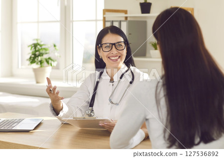 Woman sitting back in the doctor's office and listening the recommendations. 127536892