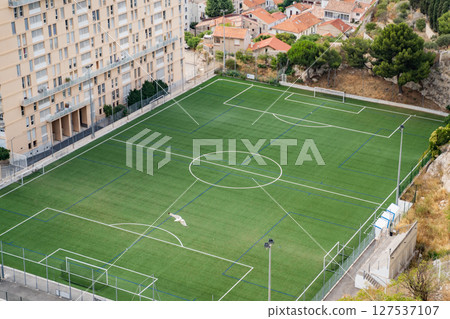 Aerial view of a soccer field located next to an apartment complex Aerial view of a soccer field located next to an apartment complex 127537107