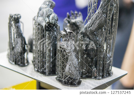 An object printed on a 3D printer from hardened rubber close-up. Model black color created on a 3D printer from hardened rubber under influence of ultraviolet light. SLA 3D printing. Stereolithography 127537245