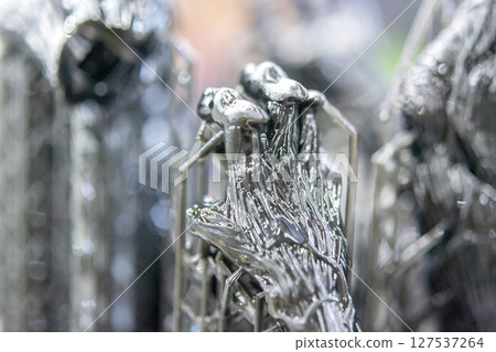 An object printed on a 3D printer from hardened rubber close-up. Model black color created on a 3D printer from hardened rubber under influence of ultraviolet light. SLA 3D printing. Stereolithography 127537264