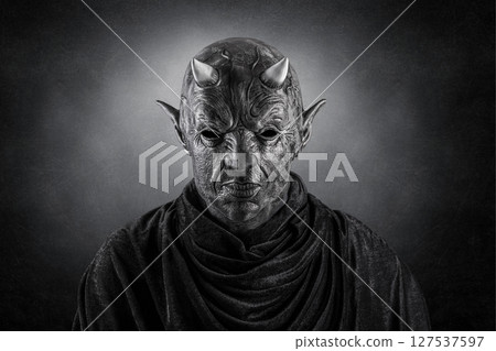 Portrait of a bad devil with horns on head over dark misty background Portrait of a bad devil with horns on head over dark misty background 127537597
