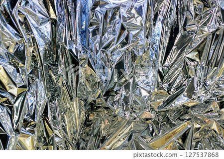 Here is a detailed closeup view of a pile of crumpled aluminum foil 127537868