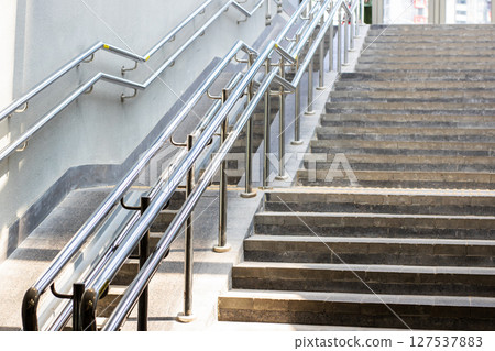A staircase featuring a sturdy metal railing for added safety and style A staircase featuring a sturdy metal railing for added safety and style 127537883