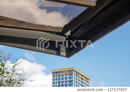 A structure standing tall with a clear blue sky and fluffy clouds behind it A structure standing tall with a clear blue sky and fluffy clouds behind it 127537887