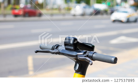 This is a detailed closeup view of the handlebars of an electric scooter 127537895
