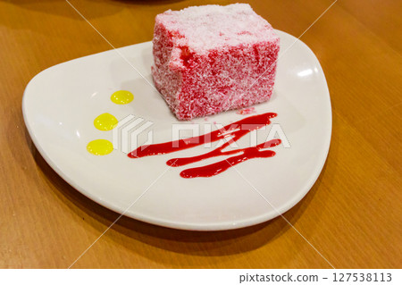 Piece of pink cake Pasta Roza on wooden table Piece of pink cake Pasta Roza on wooden table 127538113