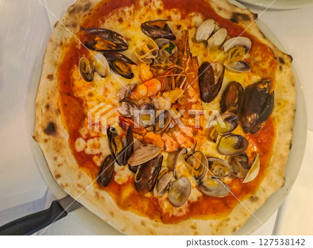 Delicious pizza with seafood in pizzeria. Top view 127538142