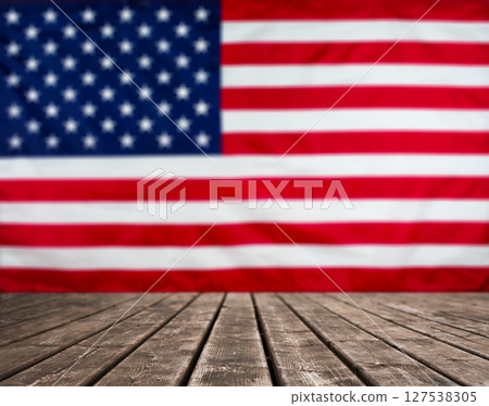 Wooden Table. Blurred American flag background with copy space. Stock photo. Wooden Table. Blurred American flag background with copy space. Stock photo. 127538305