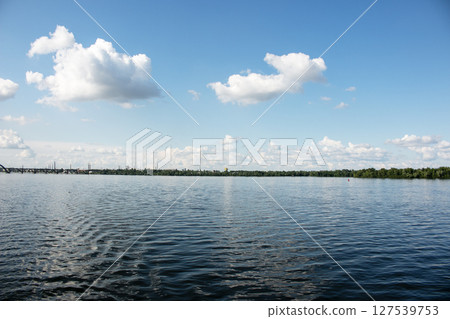 Panoramic view of the city of Dnepr. Ukraine. Reflection of the sky with clouds on the surface of water. 127539753