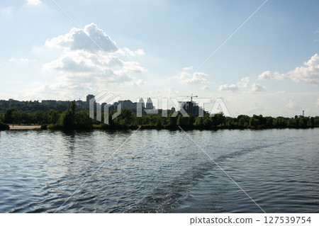 Panoramic view of the city center of Dnepr. Ukraine. Reflection of the sky with clouds on the surface of the water. Panoramic view of the city center of Dnepr. Ukraine. Reflection of the sky with clouds on the surface of the water. 127539754
