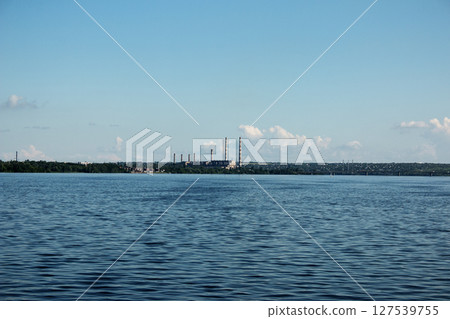 Panoramic view of the Pridneprovskaya TPP in the city of Dnepr. Ukraine. Reflection of the sky with clouds on the surface of the water. 127539755