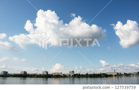 Panoramic view of the left bank of Dnieper River. Dnieper. Ukraine. Reflection of the sky with clouds on the water surface. Panoramic view of the left bank of Dnieper River. Dnieper. Ukraine. Reflection of the sky with clouds on the water surface. 127539759