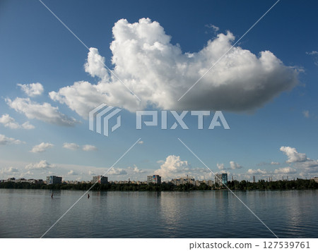 Panoramic view of left bank of Dnieper River. Dnieper. Ukraine. Reflection of the sky with clouds on the water surface. 127539761