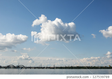 Panoramic view of the city of Dnepr. Ukraine. Reflection of sky with clouds on the surface of the water. 127539789