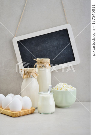Various dairy products and eggs with framed chalk board 127540011