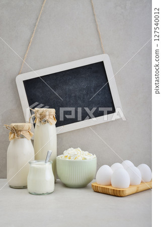 Various dairy products and eggs with framed chalk board Various dairy products and eggs with framed chalk board 127540012