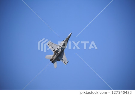 Hornet fighter jet performing acrobatic flying 127540483
