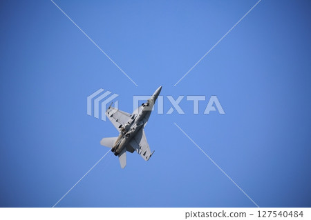 Hornet fighter jet performing acrobatic flying 127540484
