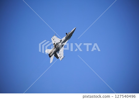 Hornet fighter jet performing acrobatic flying 127540496