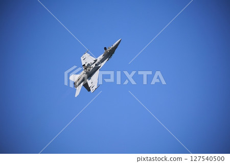 Hornet fighter jet performing acrobatic flying 127540500