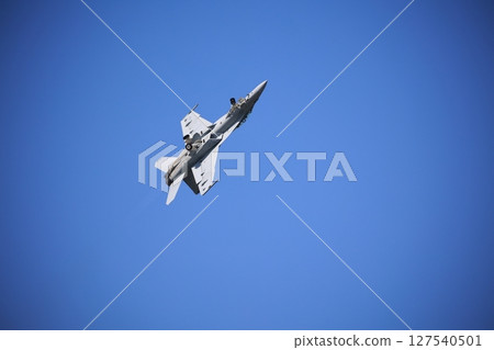 Hornet fighter jet performing acrobatic flying 127540501