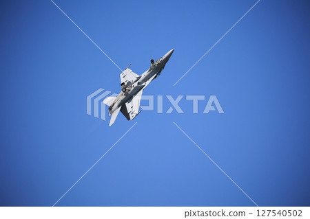 Hornet fighter jet performing acrobatic flying 127540502