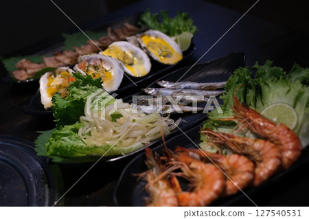Gourmet Assorted Seafood Platter With Mussels, Salmon, Shrimp, and Octopus on Elegant Tableware. Gourmet Assorted Seafood Platter With Mussels, Salmon, Shrimp, and Octopus on Elegant Tableware. 127540531